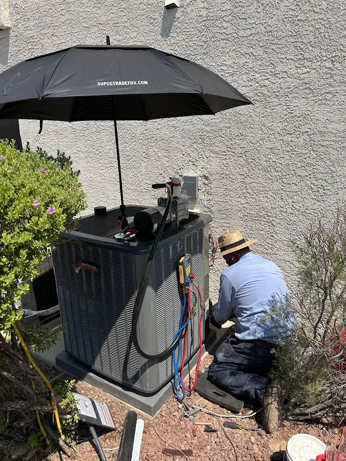 HVAC technician performing outdoor AC maintenance in Le Roy